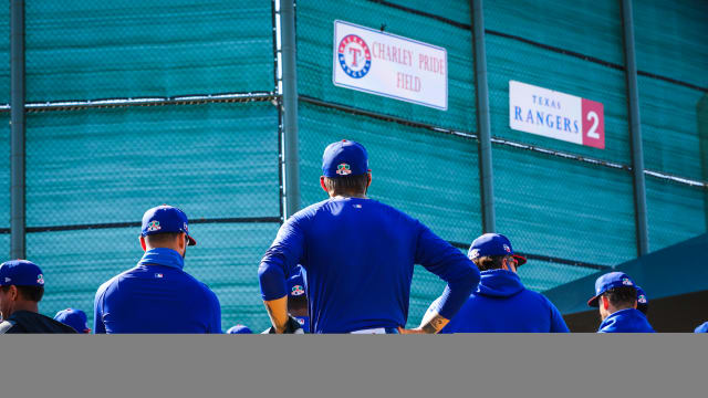 Players observe the unveiling of Charley Pride Field at the Texas Rangers spring training complex in Surprise, Arizona.